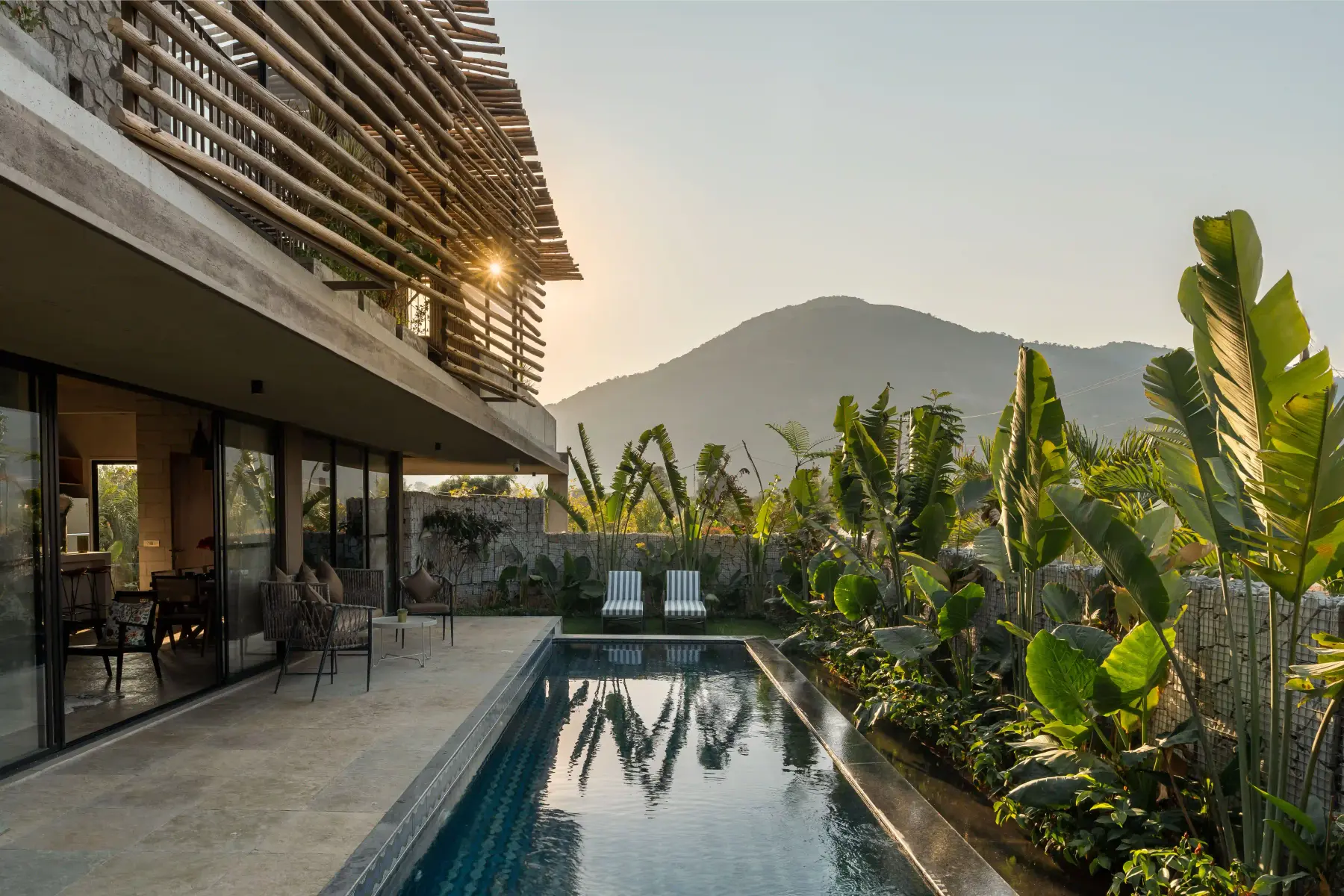 The lap pool at Villa Maaya catching the last light, with the Nandi hills behind
