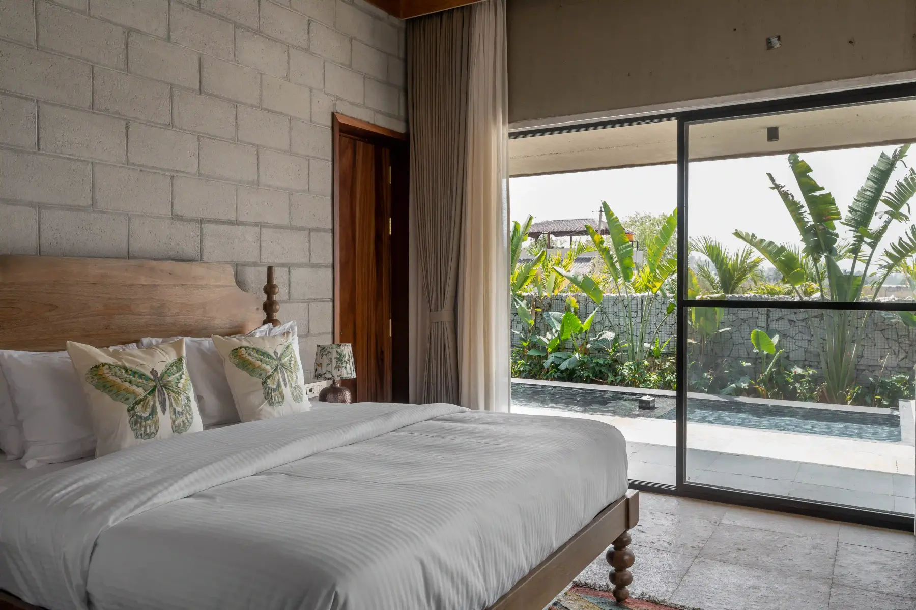 Bedroom at Villa Maaya opening onto the pool