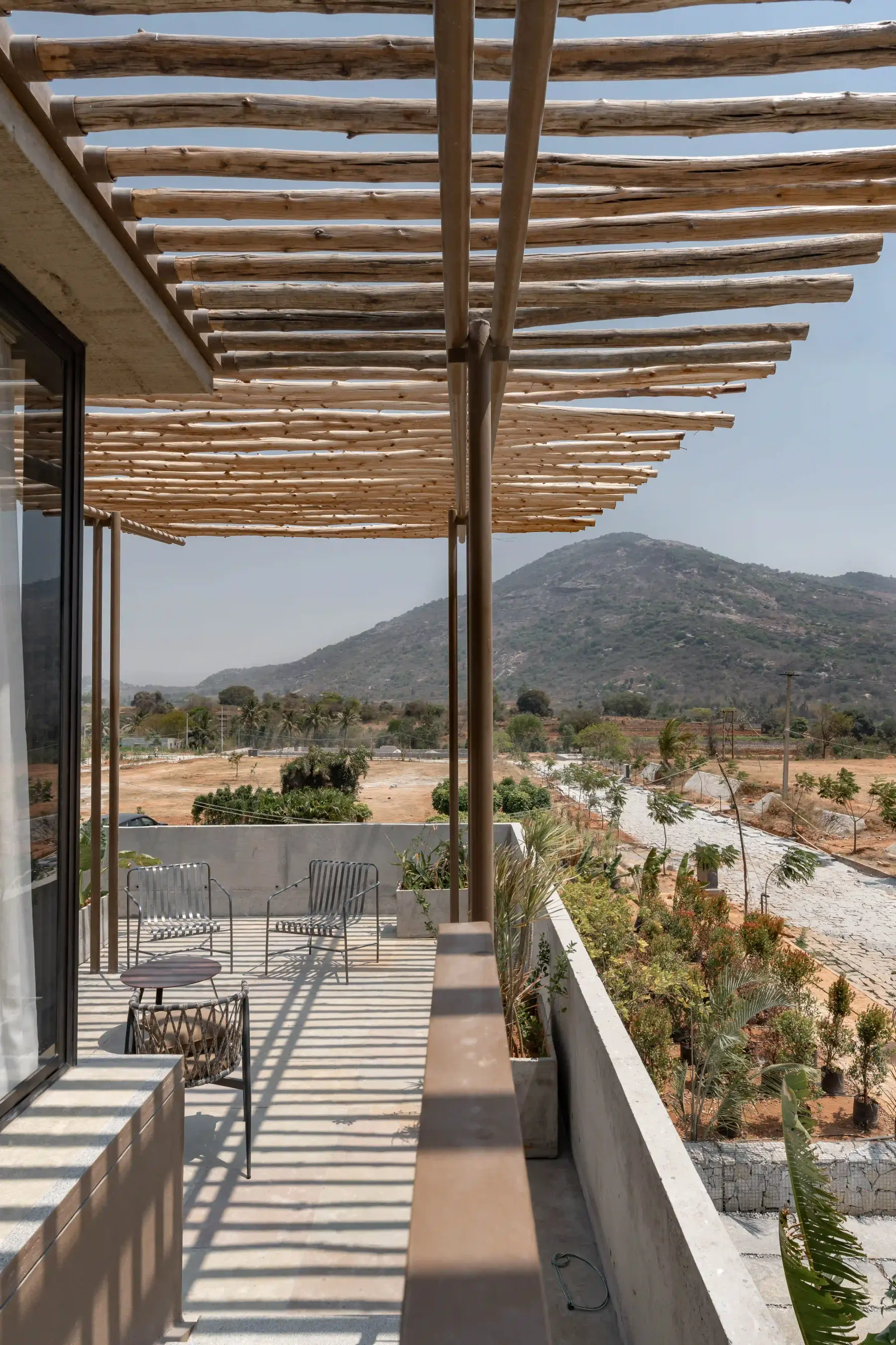 Pergola-shaded terrace at Villa Maaya looking out to the hills