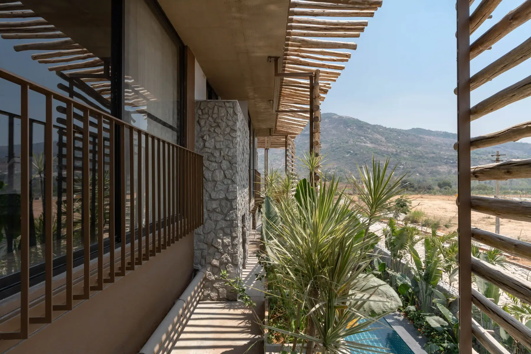 Planted corridor running alongside the pool at Villa Maaya