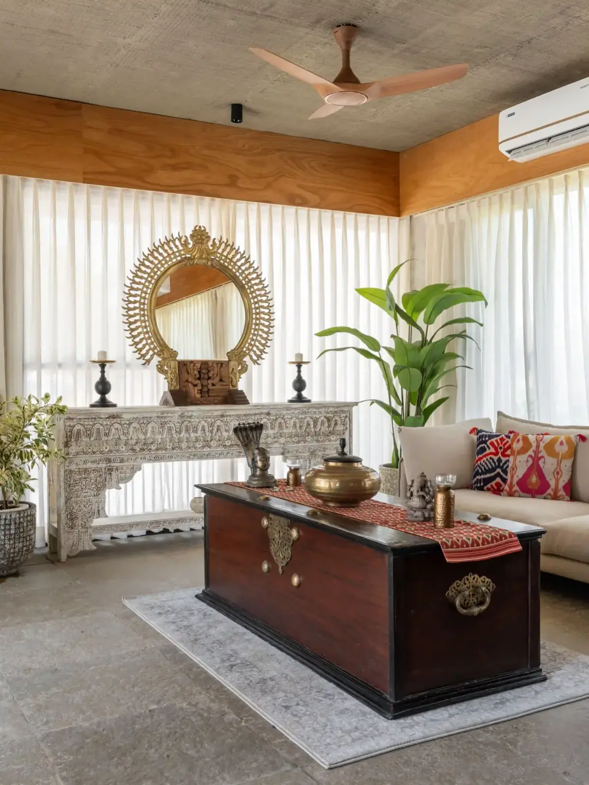 A living room at Villa Nirvaana with a carved console and soft seating