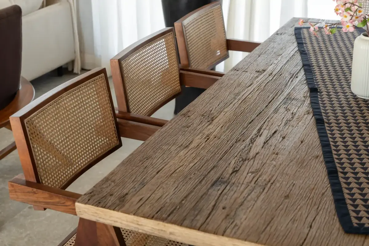 Cane chairs and a reclaimed timber table at Villa Nirvaana