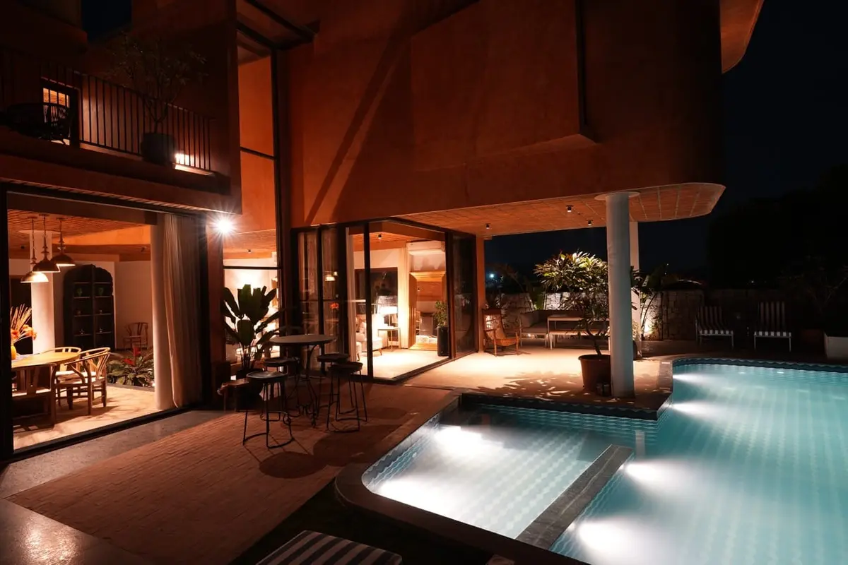 Villa Praana's pool lit from within at dusk